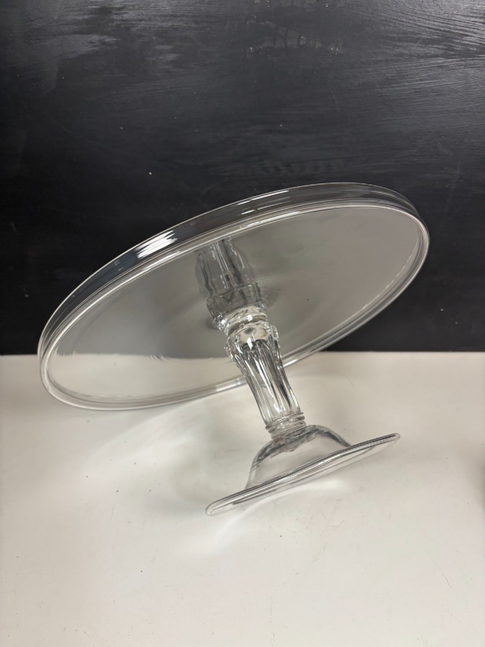 A clear glass George III tazza featuring a wide circular tray supported by a turned stem and a circular footed base. View IV