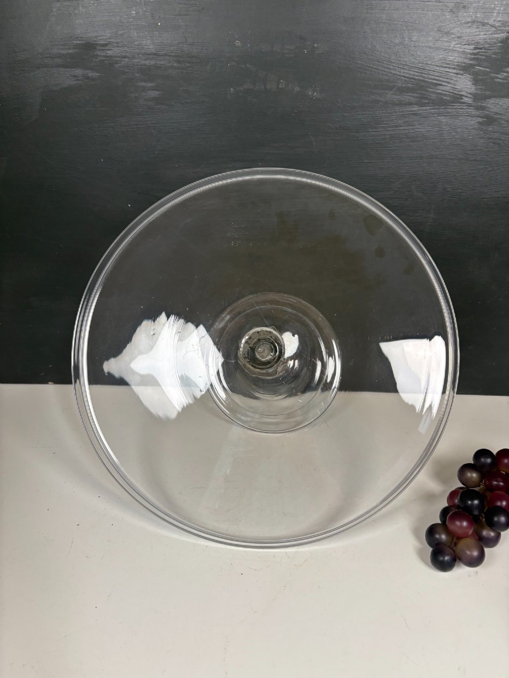 A clear glass George III tazza featuring a wide circular tray supported by a turned stem and a circular footed base. View VI