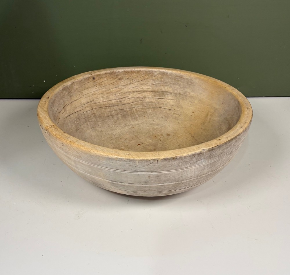A nineteenth-century turned sycamore dairy bowl featuring horizontal scribed lines along the exterior and a naturally aged timber patina. View II