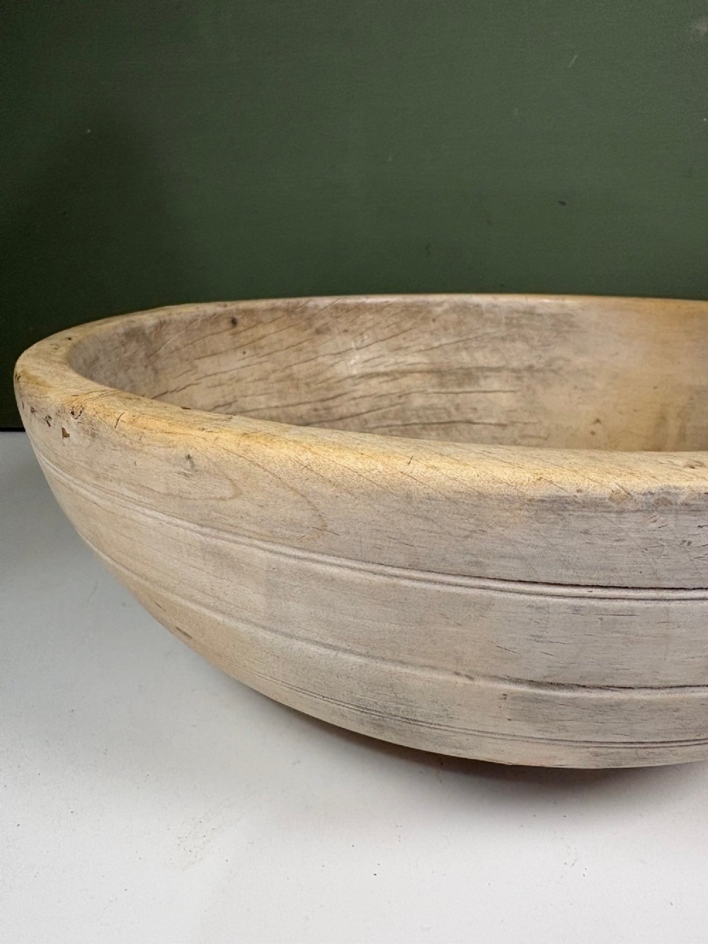 A nineteenth-century turned sycamore dairy bowl featuring horizontal scribed lines along the exterior and a naturally aged timber patina. View V