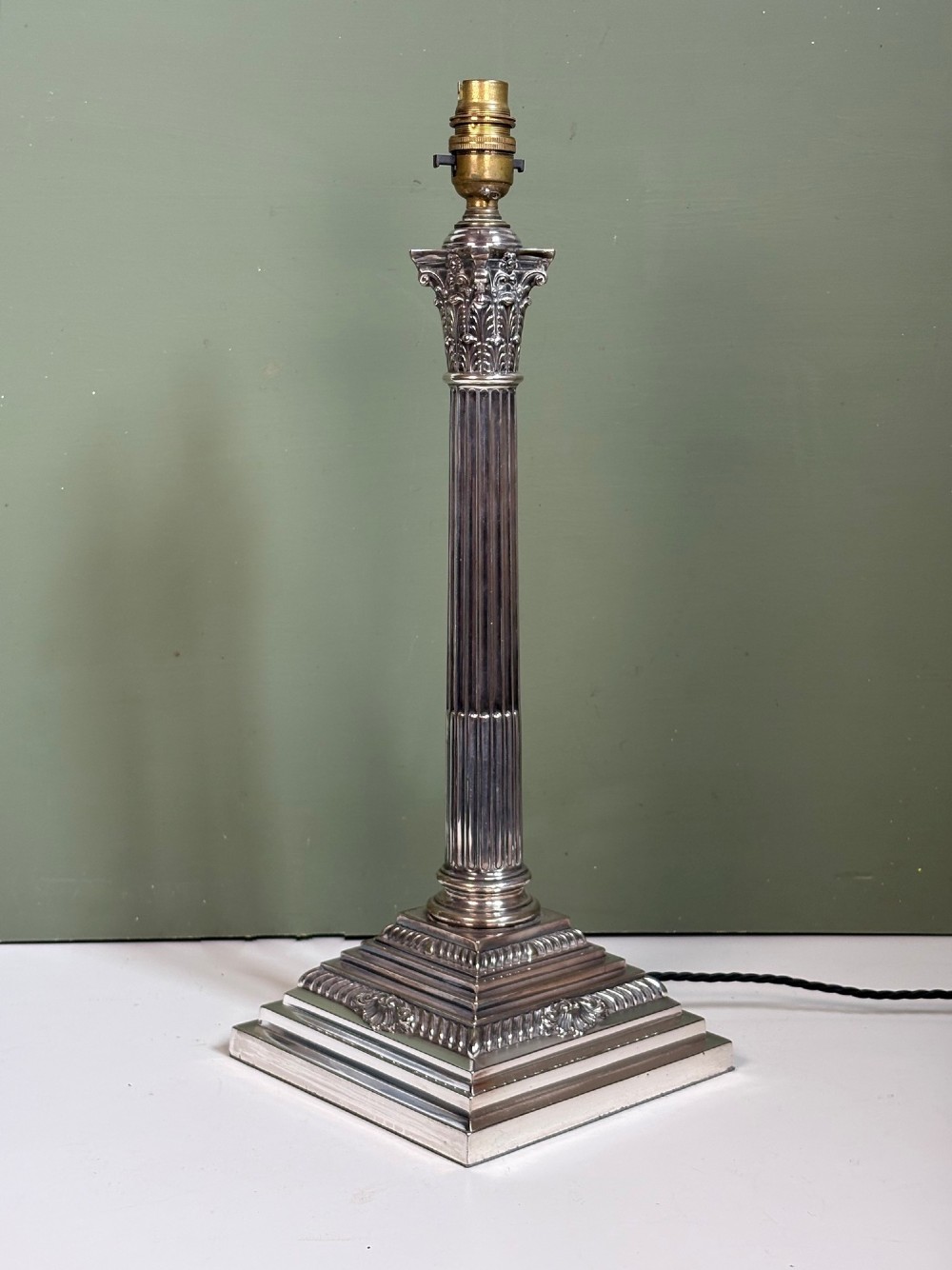 A 19th-century silver-plated Corinthian column table lamp base featuring a fluted stem, detailed capital, and stepped square pedestal base. View II