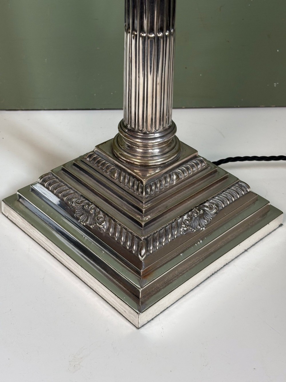 A 19th-century silver-plated Corinthian column table lamp base featuring a fluted stem, detailed capital, and stepped square pedestal base. View IV