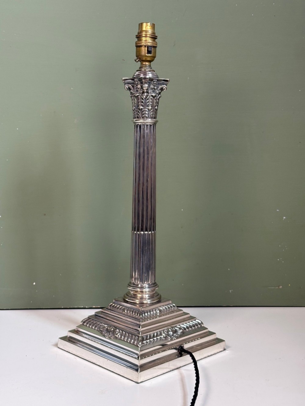 A 19th-century silver-plated Corinthian column table lamp base featuring a fluted stem, detailed capital, and stepped square pedestal base. View V