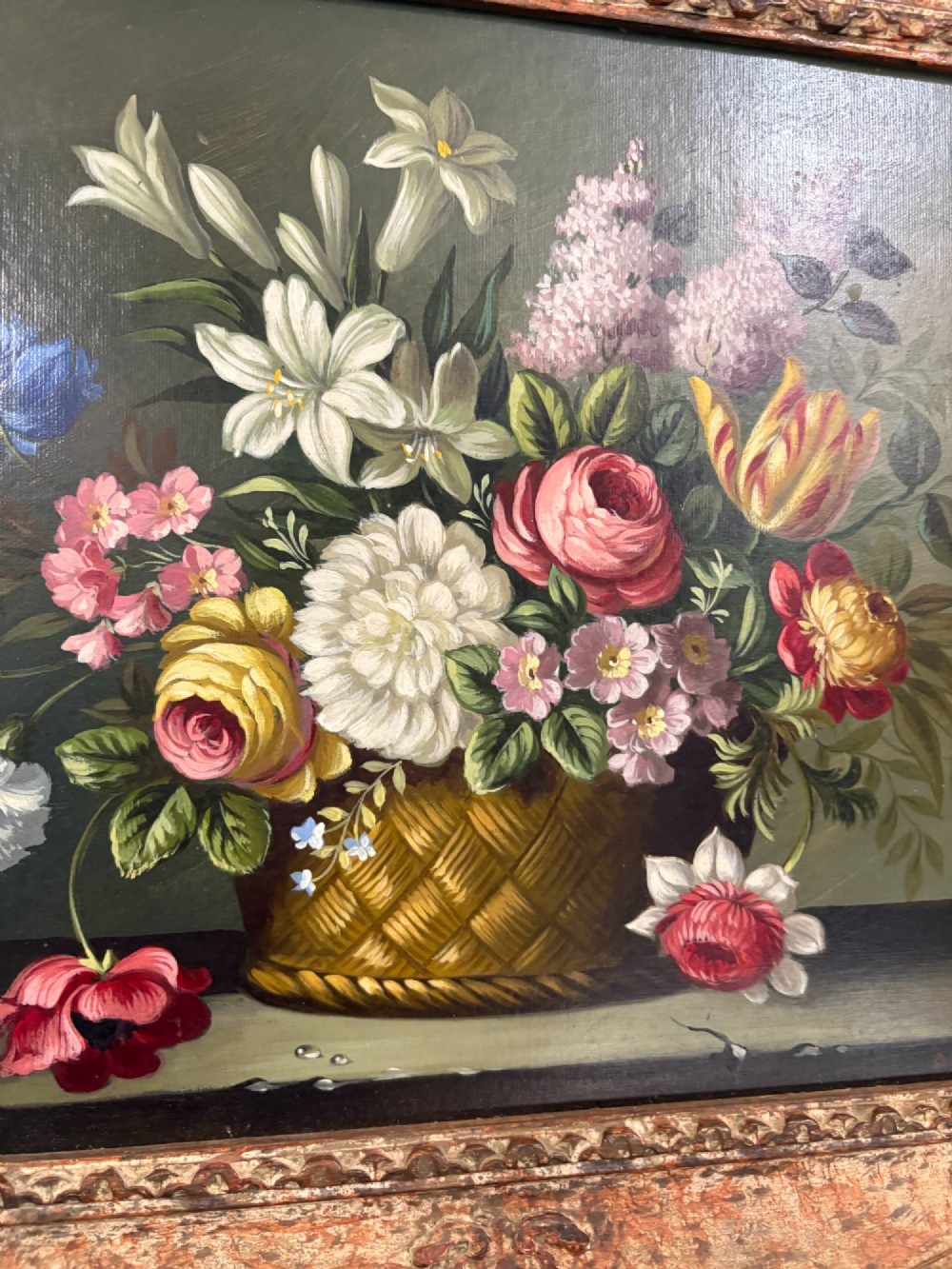 A pair of 19th-century oil paintings displaying botanical floral arrangements in woven baskets within ornate swept gilt frames. View IV
