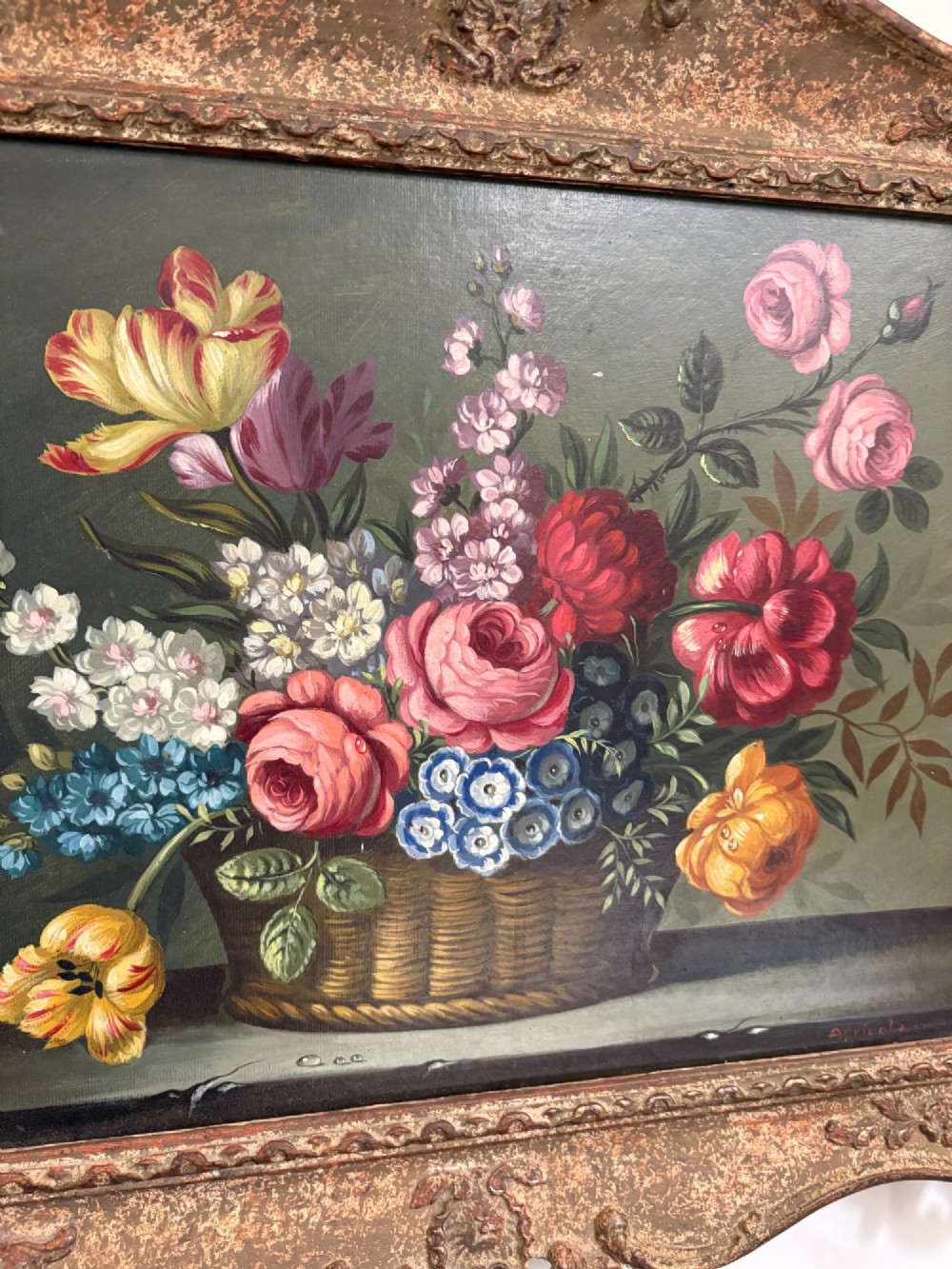 A pair of 19th-century oil paintings displaying botanical floral arrangements in woven baskets within ornate swept gilt frames. View V