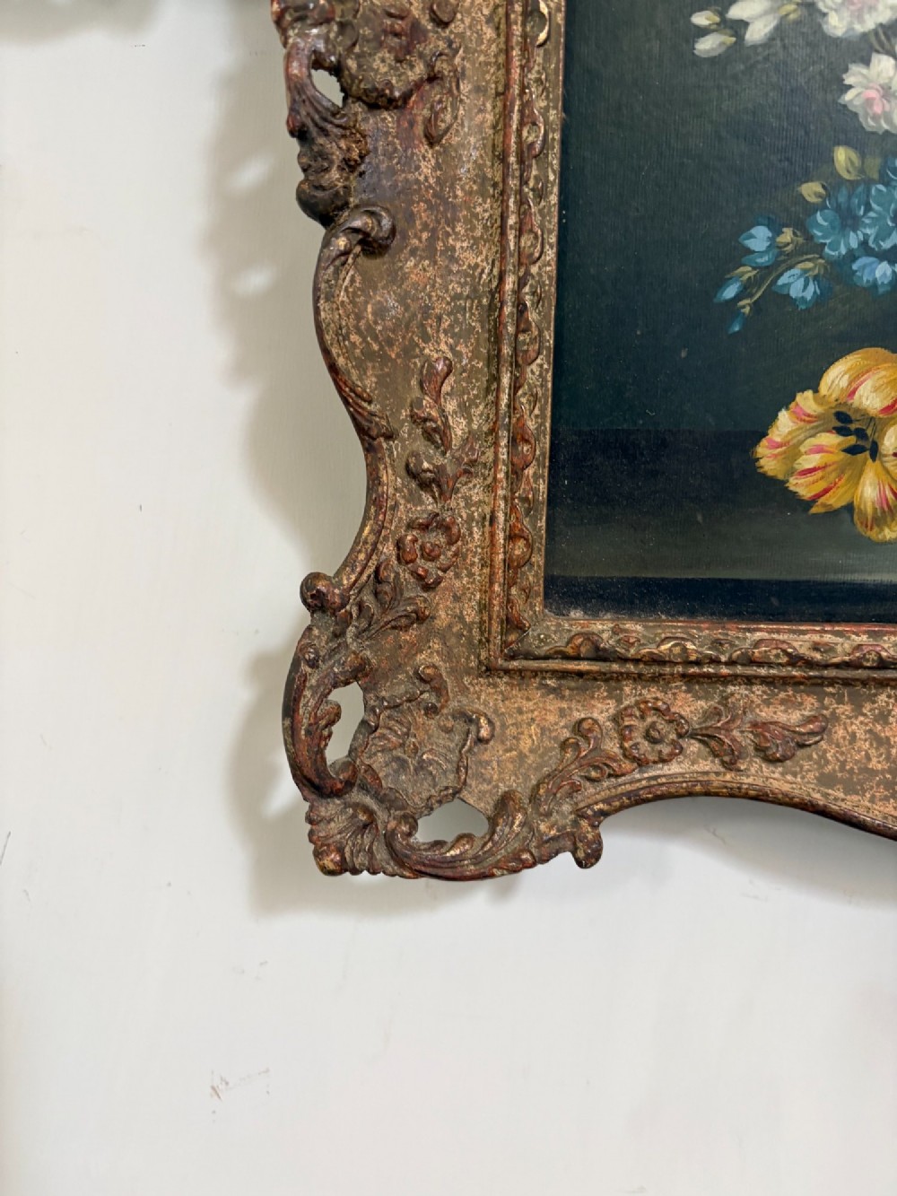 A pair of 19th-century oil paintings displaying botanical floral arrangements in woven baskets within ornate swept gilt frames. View VI