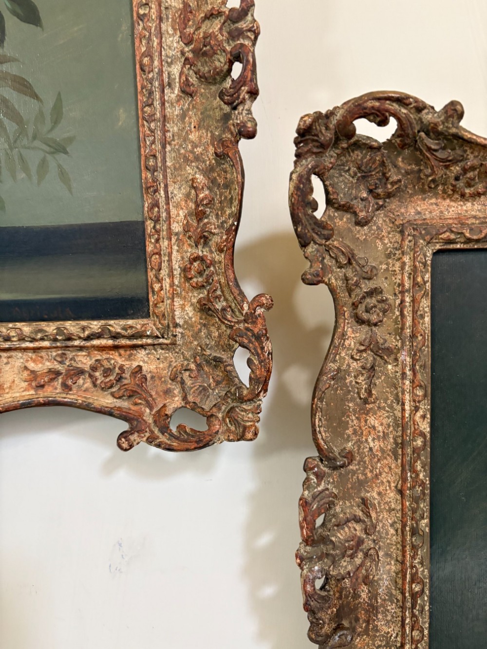 A pair of 19th-century oil paintings displaying botanical floral arrangements in woven baskets within ornate swept gilt frames. View VII