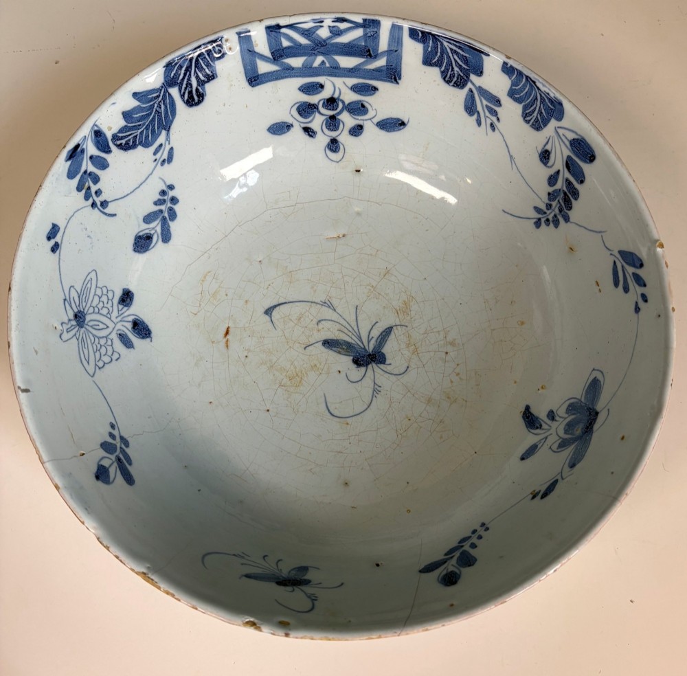 An 18th-century blue and white tin-glazed earthenware bowl with hand-painted cobalt blue botanical decoration. View III