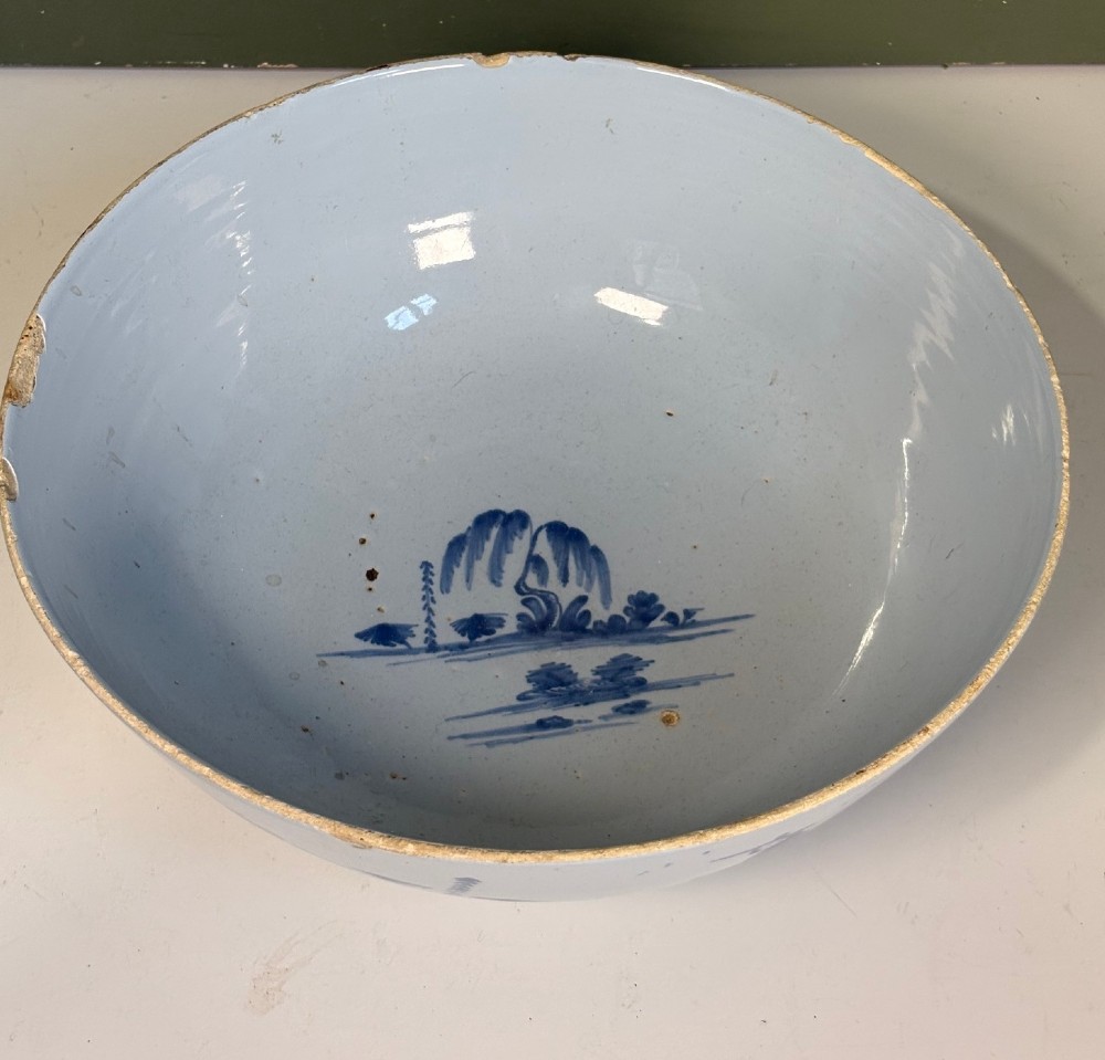 An 18th-century tin-glazed earthenware bowl decorated with hand-painted cobalt blue figurative scenes on a footed base. View III