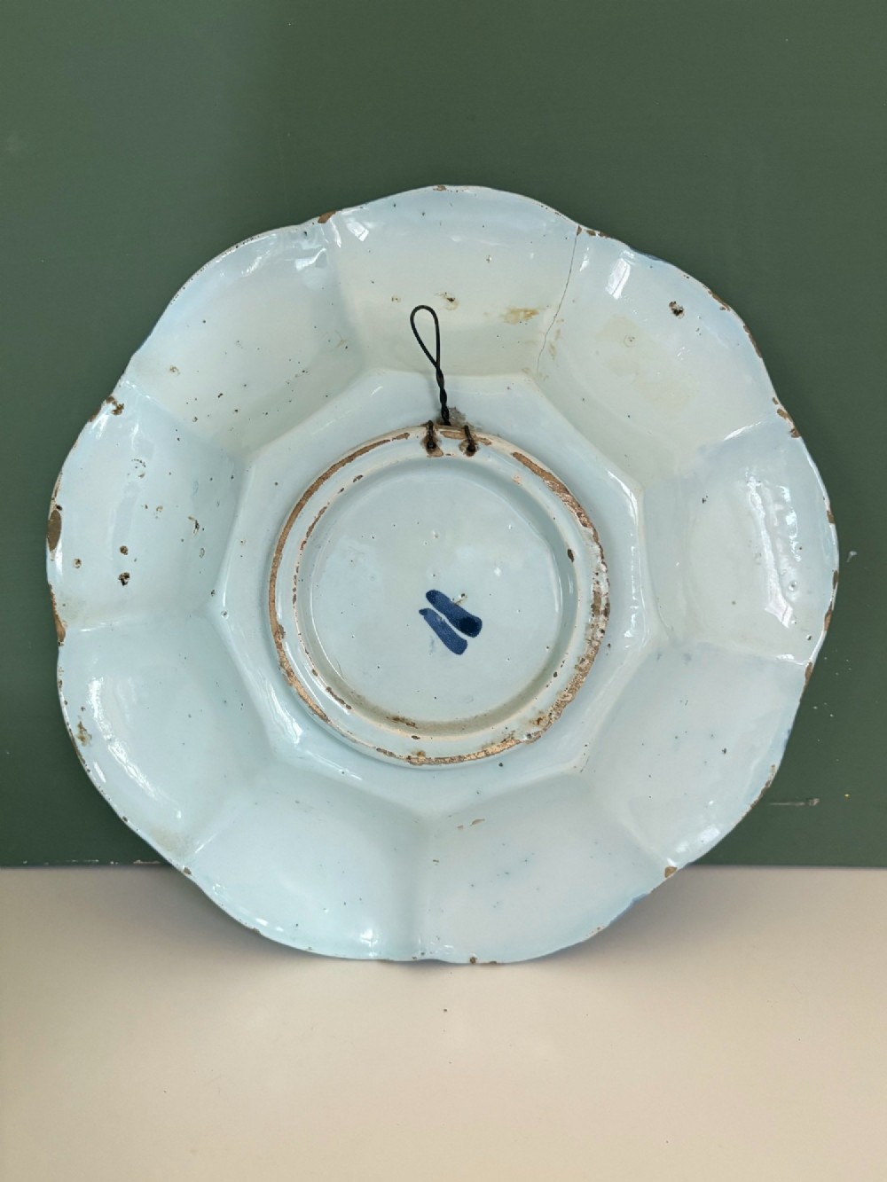 An 18th-century scalloped tin-glazed earthenware dish decorated with hand-painted cobalt blue Chinoiserie figures and floral patterns. View VI