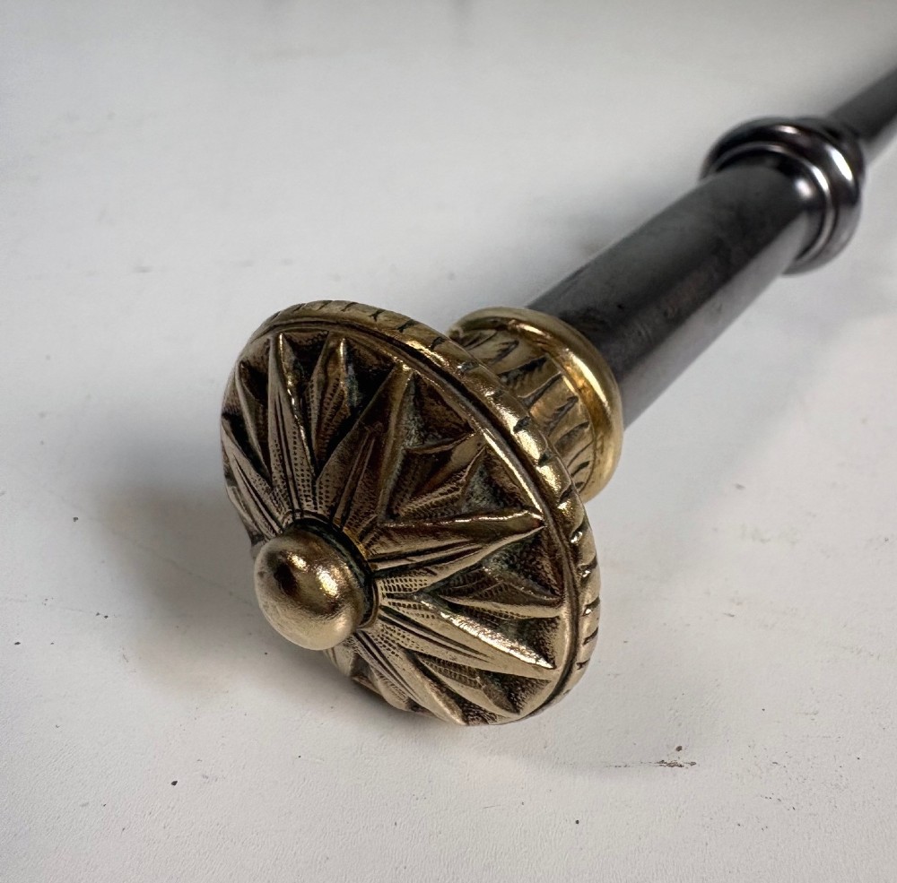 A set of three 18th-century steel fire tools, including a poker, tongs, and a pierced shovel, topped with decorative brass finials. View VII