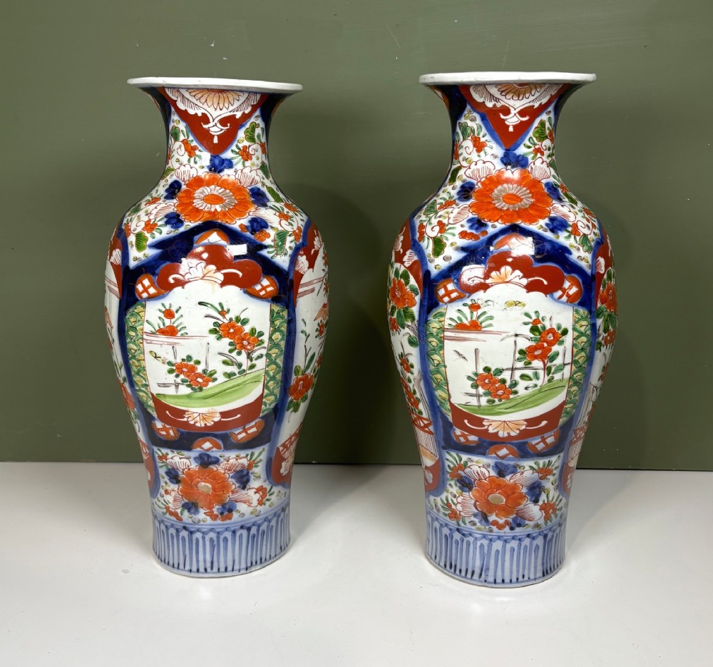 A matching pair of nineteenth-century Japanese Imari porcelain vases featuring hand-painted floral panels, bird motifs, and intricate cobalt blue and iron-red geometric patterns. View II