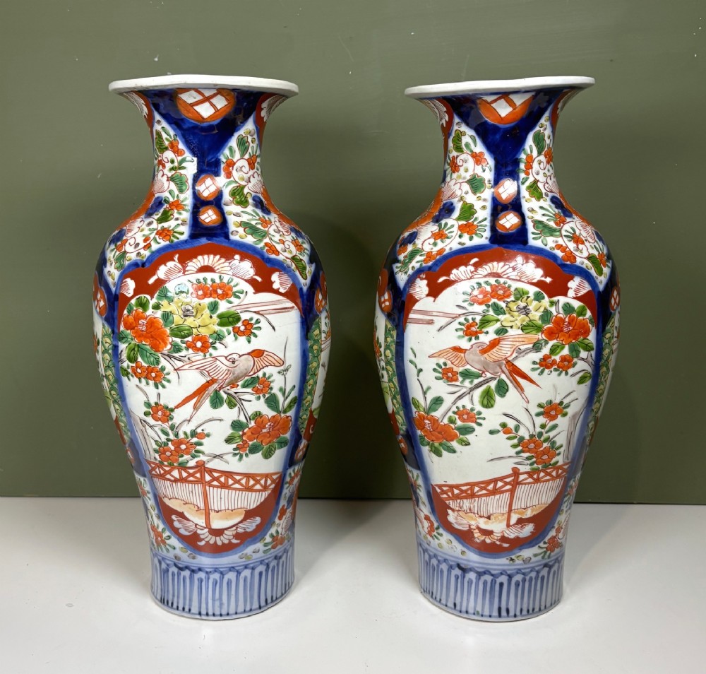A matching pair of nineteenth-century Japanese Imari porcelain vases featuring hand-painted floral panels, bird motifs, and intricate cobalt blue and iron-red geometric patterns. View III