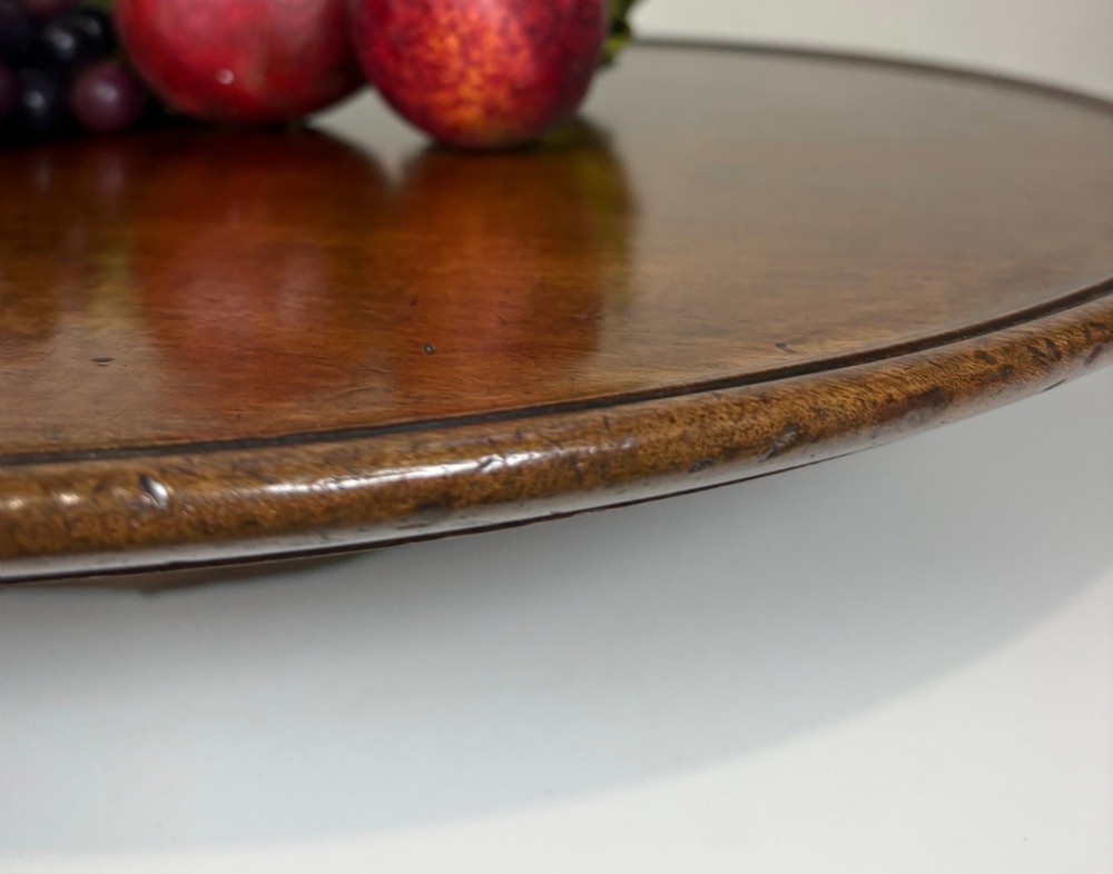 A large circular nineteenth-century mahogany lazy susan featuring a moulded rim and resting on a low pedestal base. View III