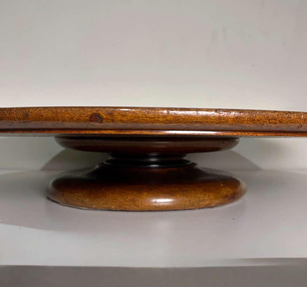 A large circular nineteenth-century mahogany lazy susan featuring a moulded rim and resting on a low pedestal base. View IV
