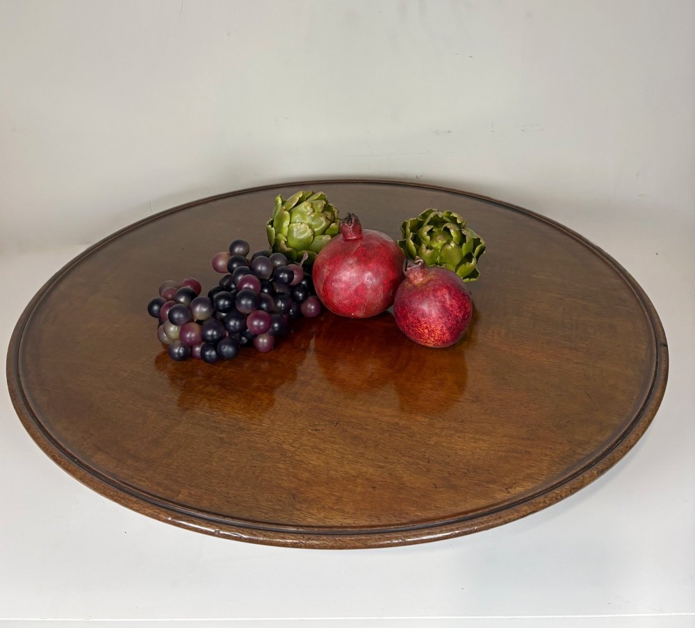 A large circular nineteenth-century mahogany lazy susan featuring a moulded rim and resting on a low pedestal base. View V