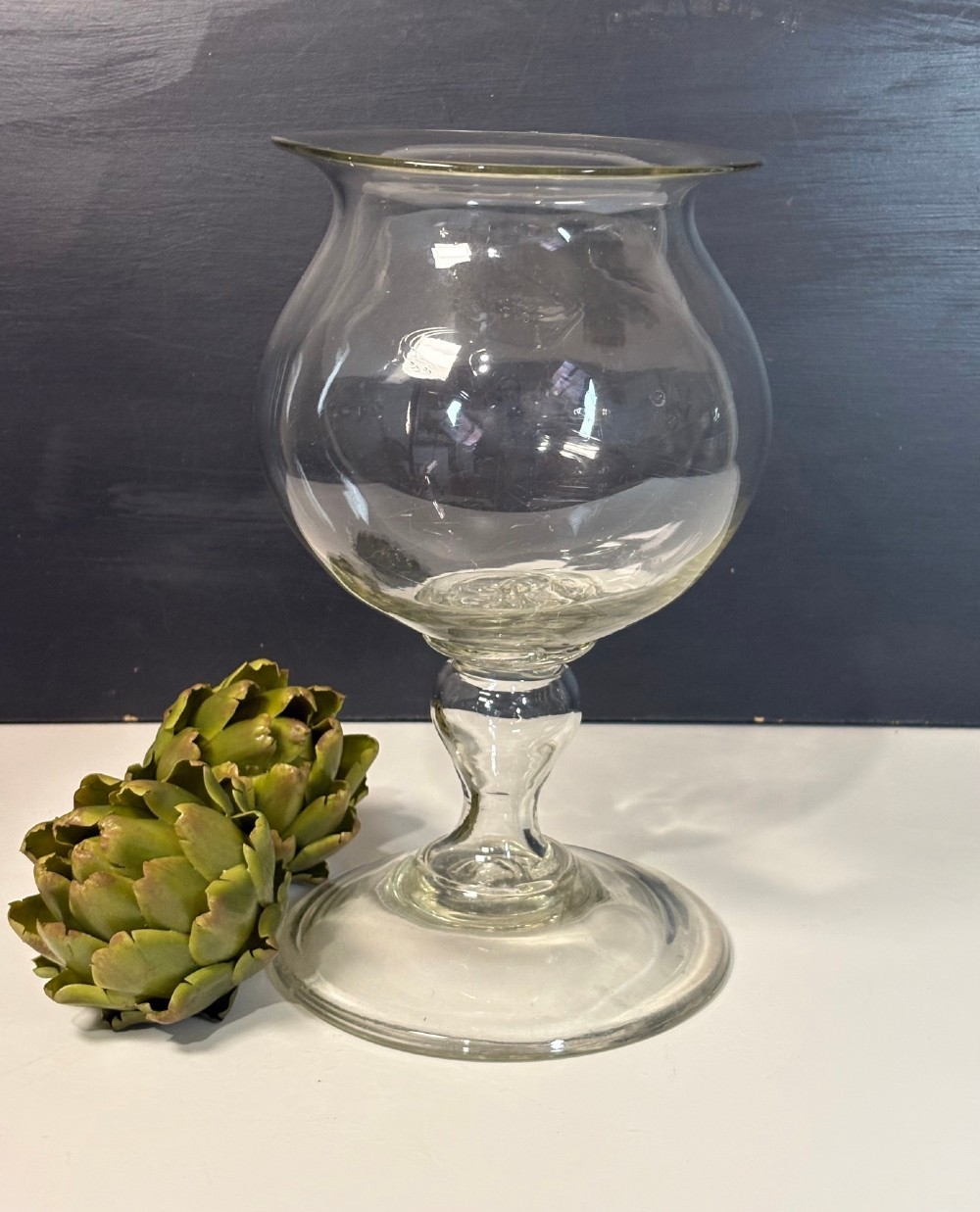 An 18th-century clear hand-blown glass leech jar featuring a wide flared rim, bulbous body, knopped stem, and a wide circular pedestal foot. View II