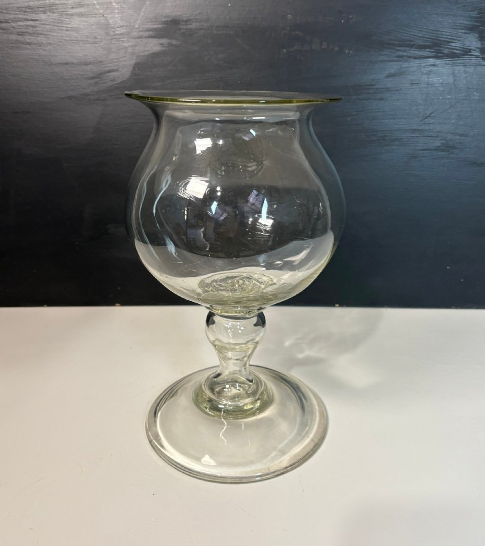 An 18th-century clear hand-blown glass leech jar featuring a wide flared rim, bulbous body, knopped stem, and a wide circular pedestal foot.