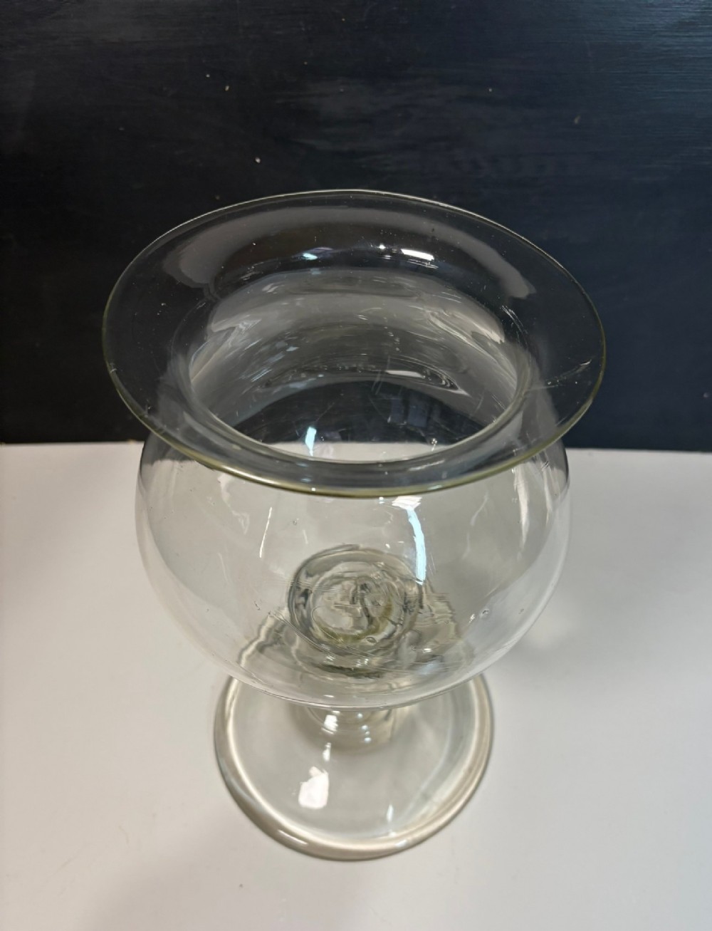 An 18th-century clear hand-blown glass leech jar featuring a wide flared rim, bulbous body, knopped stem, and a wide circular pedestal foot. View IV