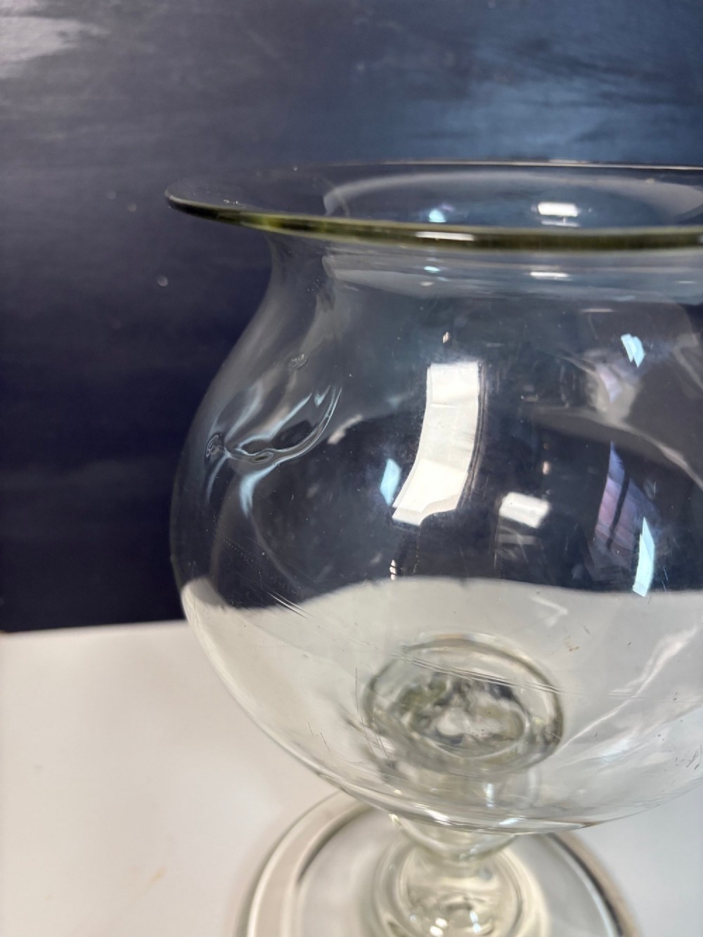An 18th-century clear hand-blown glass leech jar featuring a wide flared rim, bulbous body, knopped stem, and a wide circular pedestal foot. View VI