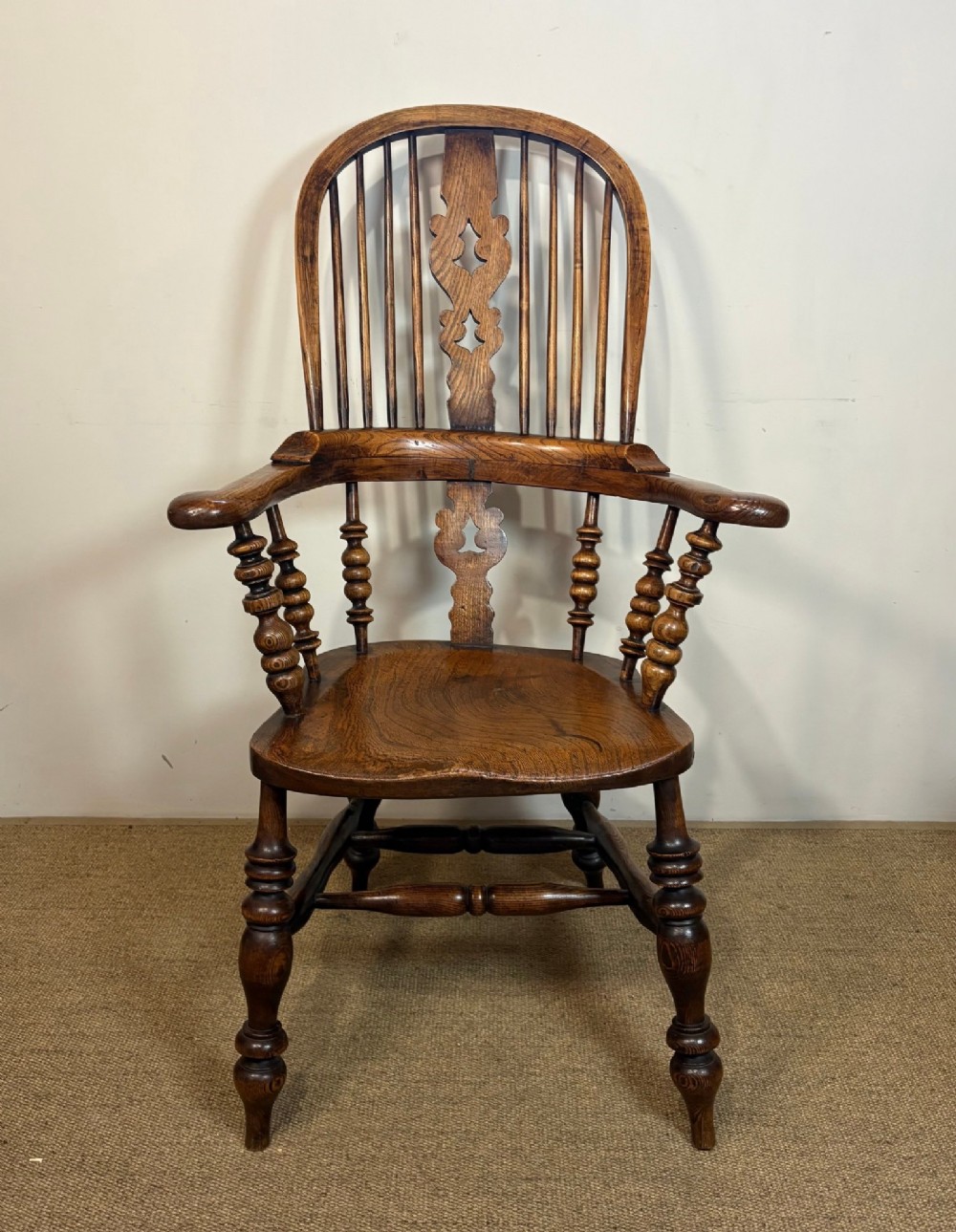 A 19th-century high-back wooden Windsor armchair featuring turned legs, a shaped seat, and a pierced back splat with vertical spindles. View II