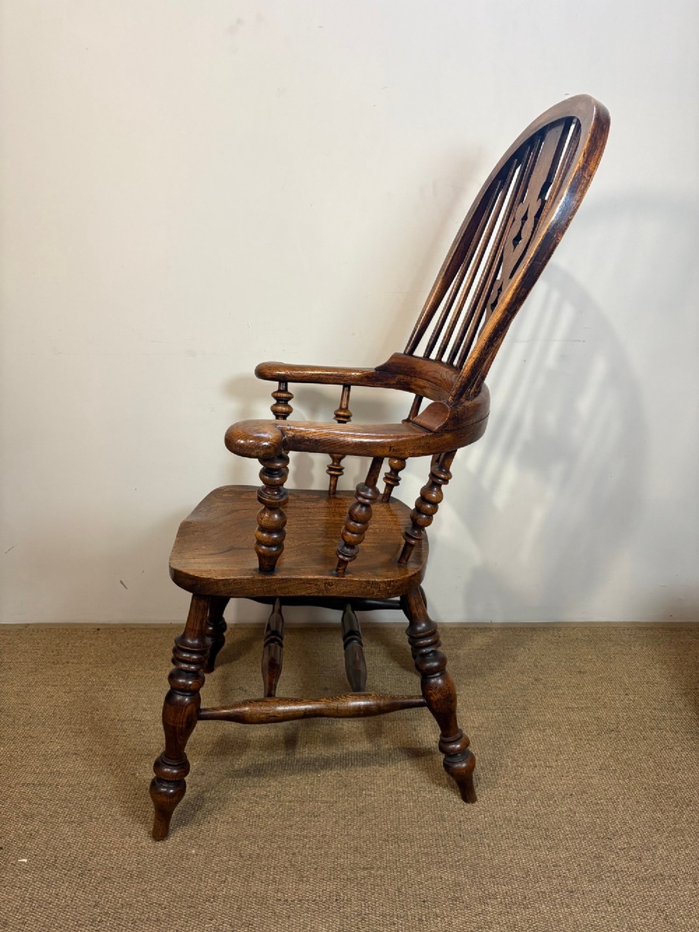 A 19th-century high-back wooden Windsor armchair featuring turned legs, a shaped seat, and a pierced back splat with vertical spindles. View III