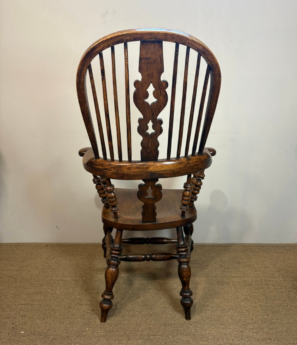 A 19th-century high-back wooden Windsor armchair featuring turned legs, a shaped seat, and a pierced back splat with vertical spindles. View IV