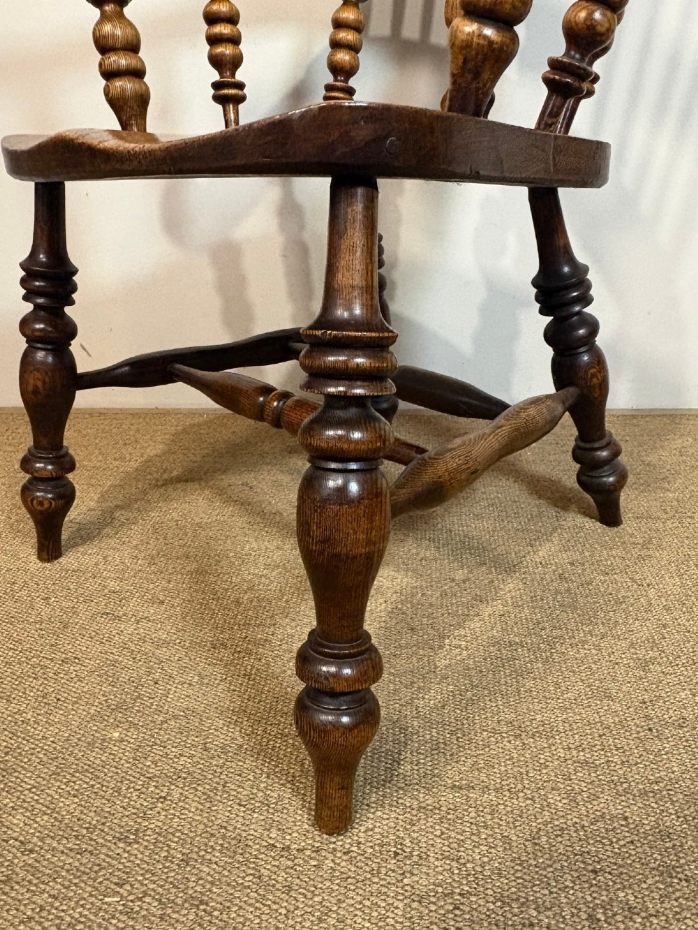 A 19th-century high-back wooden Windsor armchair featuring turned legs, a shaped seat, and a pierced back splat with vertical spindles. View VI