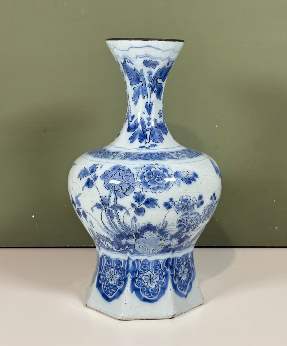 An 18th-century octagonal Delftware vase featuring hand-painted cobalt blue Chinoiserie figures and floral patterns against a white glaze. View II