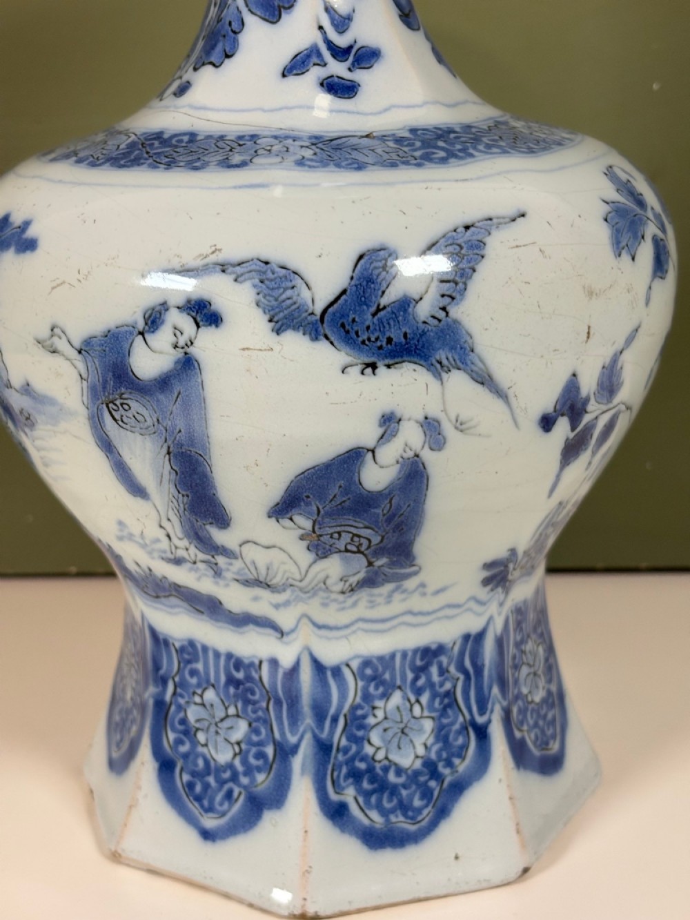 An 18th-century octagonal Delftware vase featuring hand-painted cobalt blue Chinoiserie figures and floral patterns against a white glaze. View VI