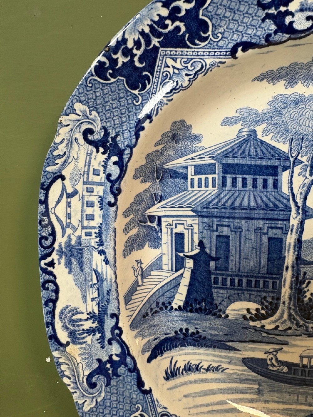 A 19th-century oval blue and white earthenware platter featuring a printed Chinoiserie landscape scene with pagodas, a river boat, and decorative scrollwork borders. View III