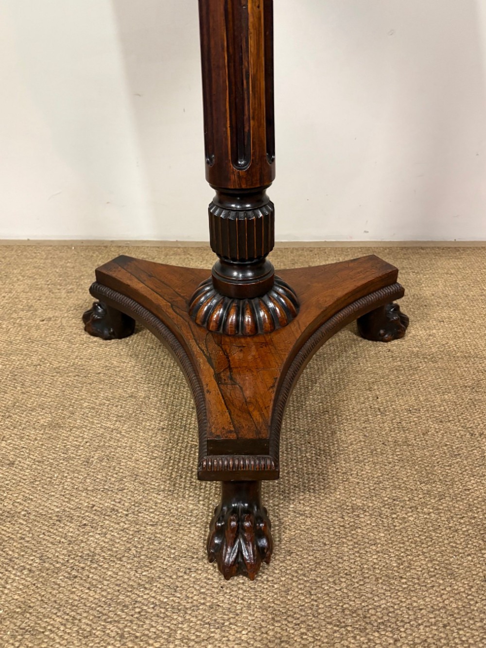 A nineteenth-century rosewood pedestal table featuring a square top, fluted central column, triform base, and carved claw feet. View II