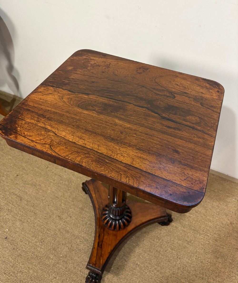 A nineteenth-century rosewood pedestal table featuring a square top, fluted central column, triform base, and carved claw feet. View IV