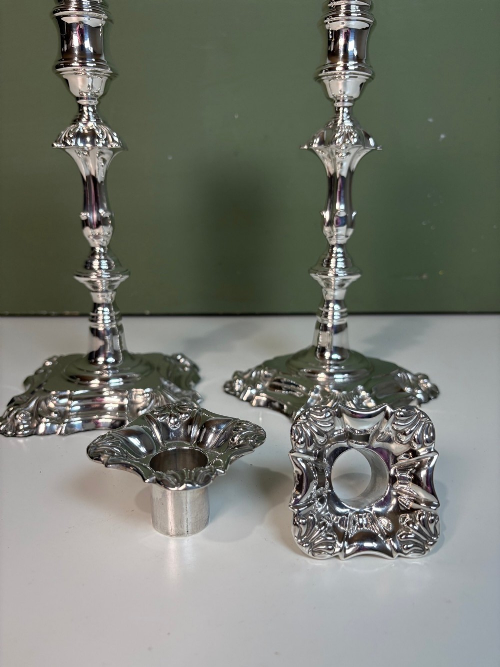 A pair of 19th-century silver candlesticks featuring Rococo style scrollwork, scalloped bases, and knopped stems. View III