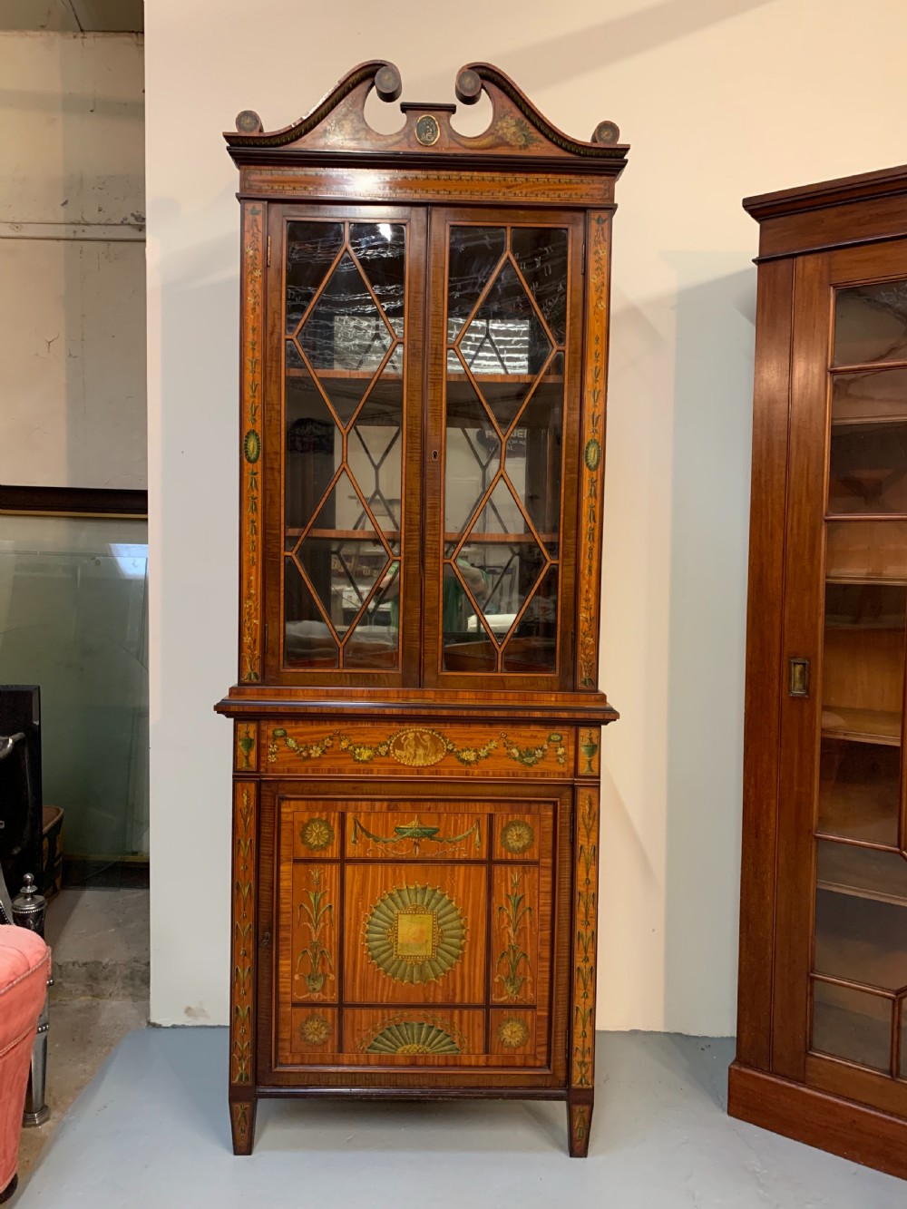Fine satinwood polychrome decorated corner cupboard 