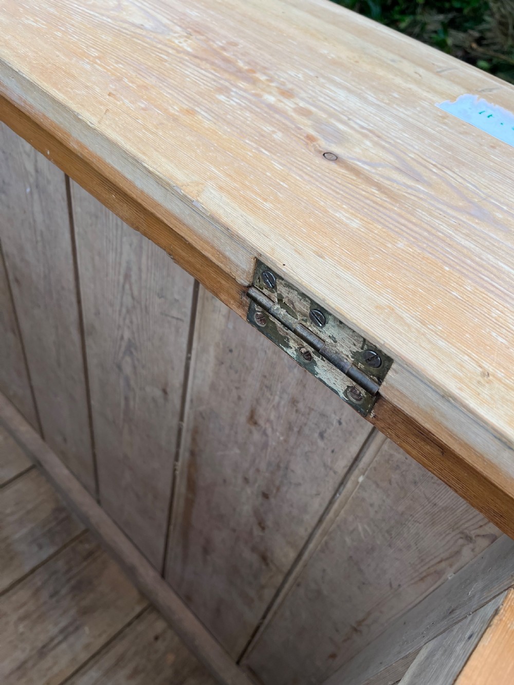 A rectangular antique pine log box featuring vertical timber panelling, a flat top surface, and a solid plinth base. View VI