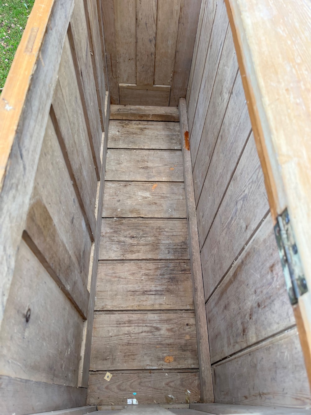 A rectangular antique pine log box featuring vertical timber panelling, a flat top surface, and a solid plinth base. View VII
