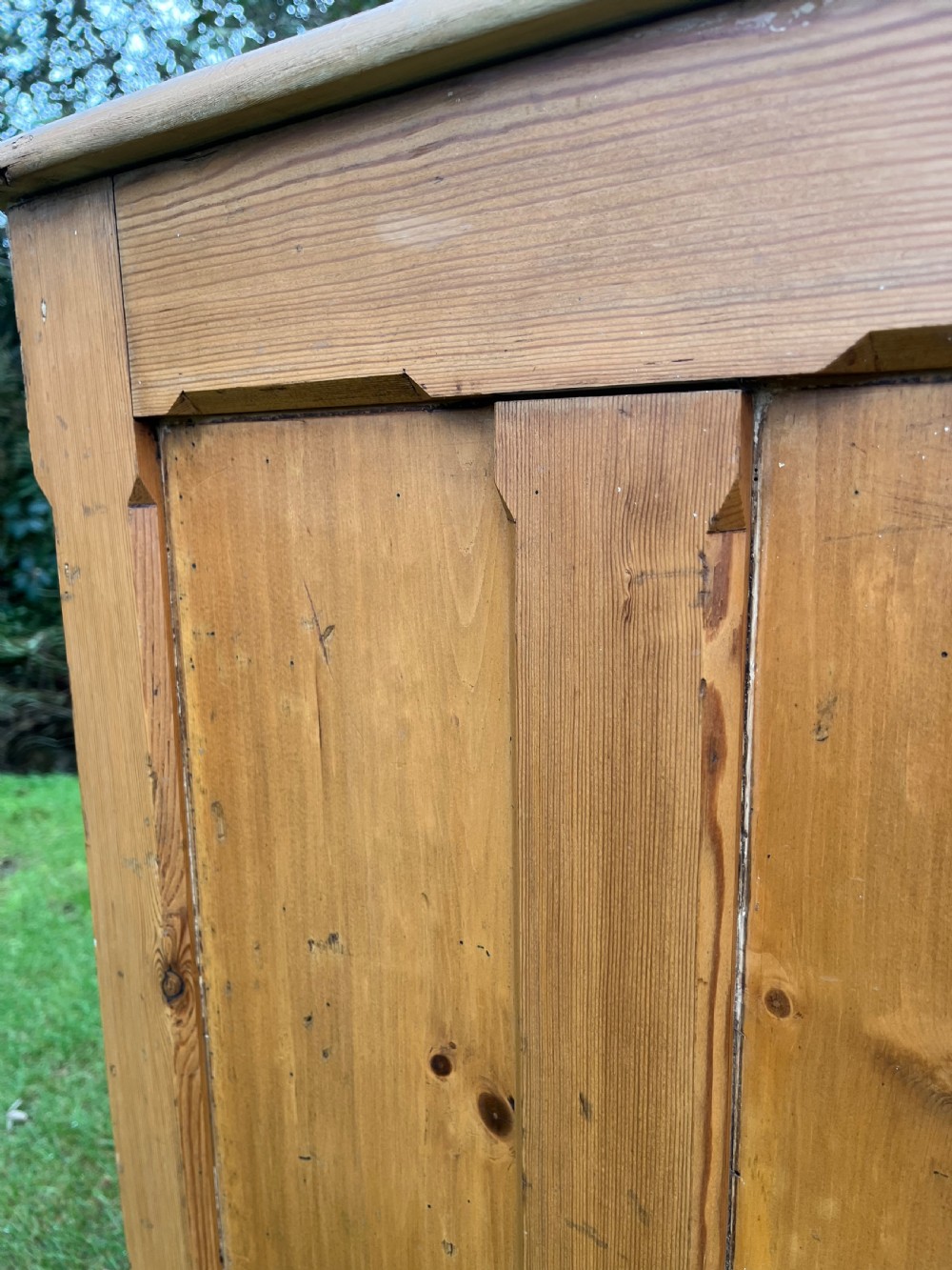A rectangular antique pine log box featuring vertical timber panelling, a flat top surface, and a solid plinth base. View VIII