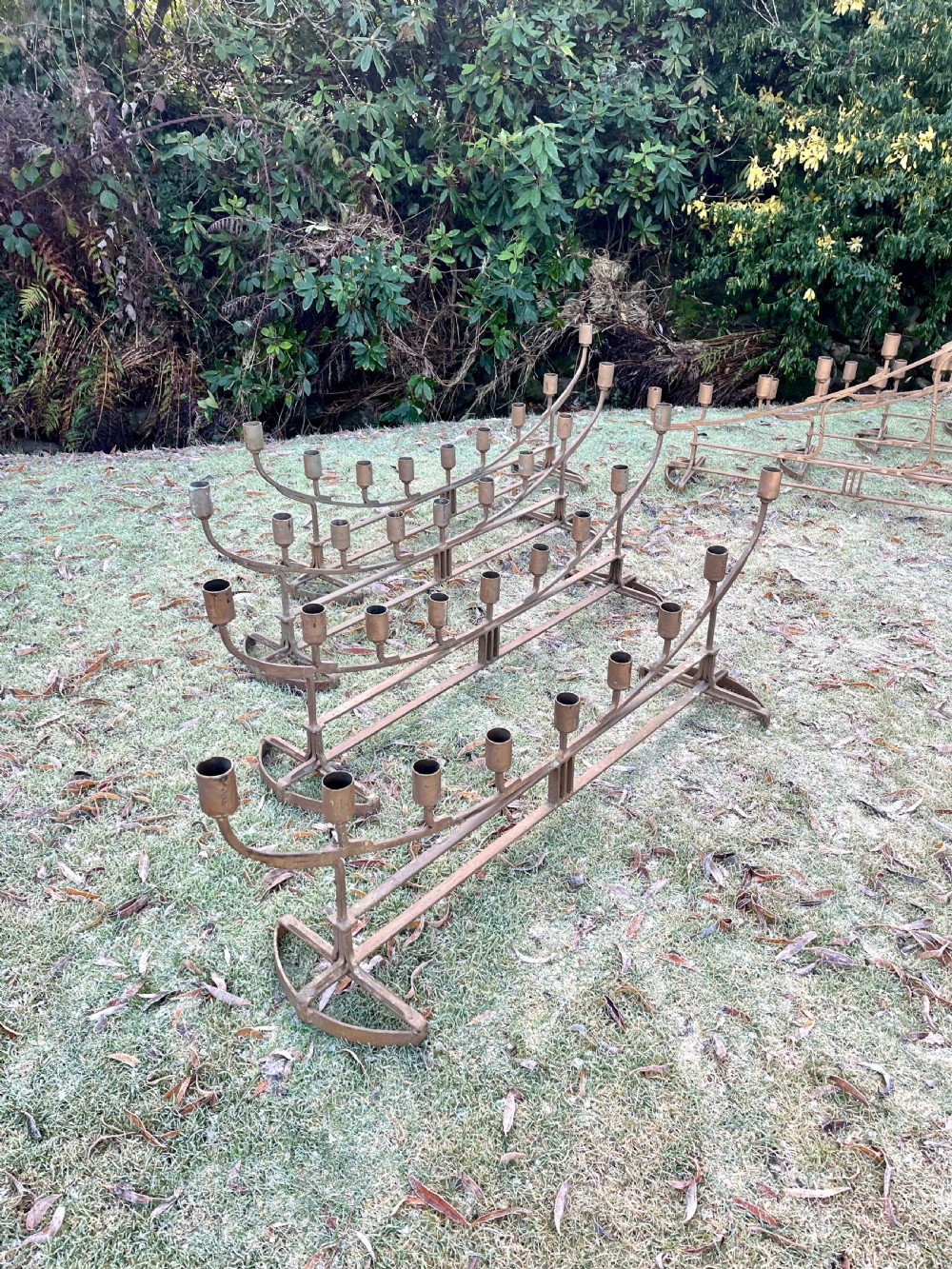 Eight large steel candlesticks  View XIV