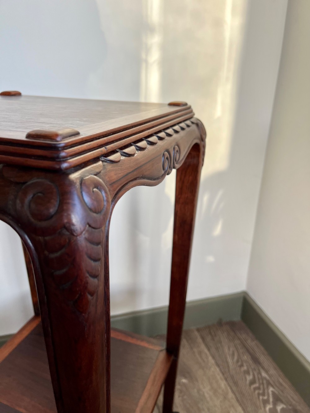 A tall, square antique rosewood lamp table featuring carved aprons, a lower shelf tier, and slender legs ending in carved feet. View III