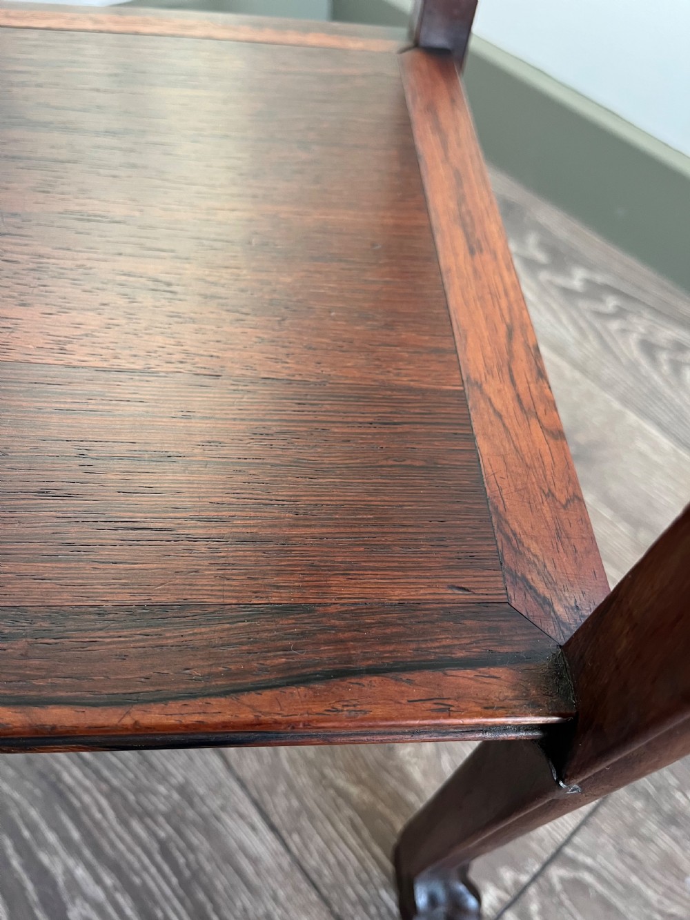 A tall, square antique rosewood lamp table featuring carved aprons, a lower shelf tier, and slender legs ending in carved feet. View VI