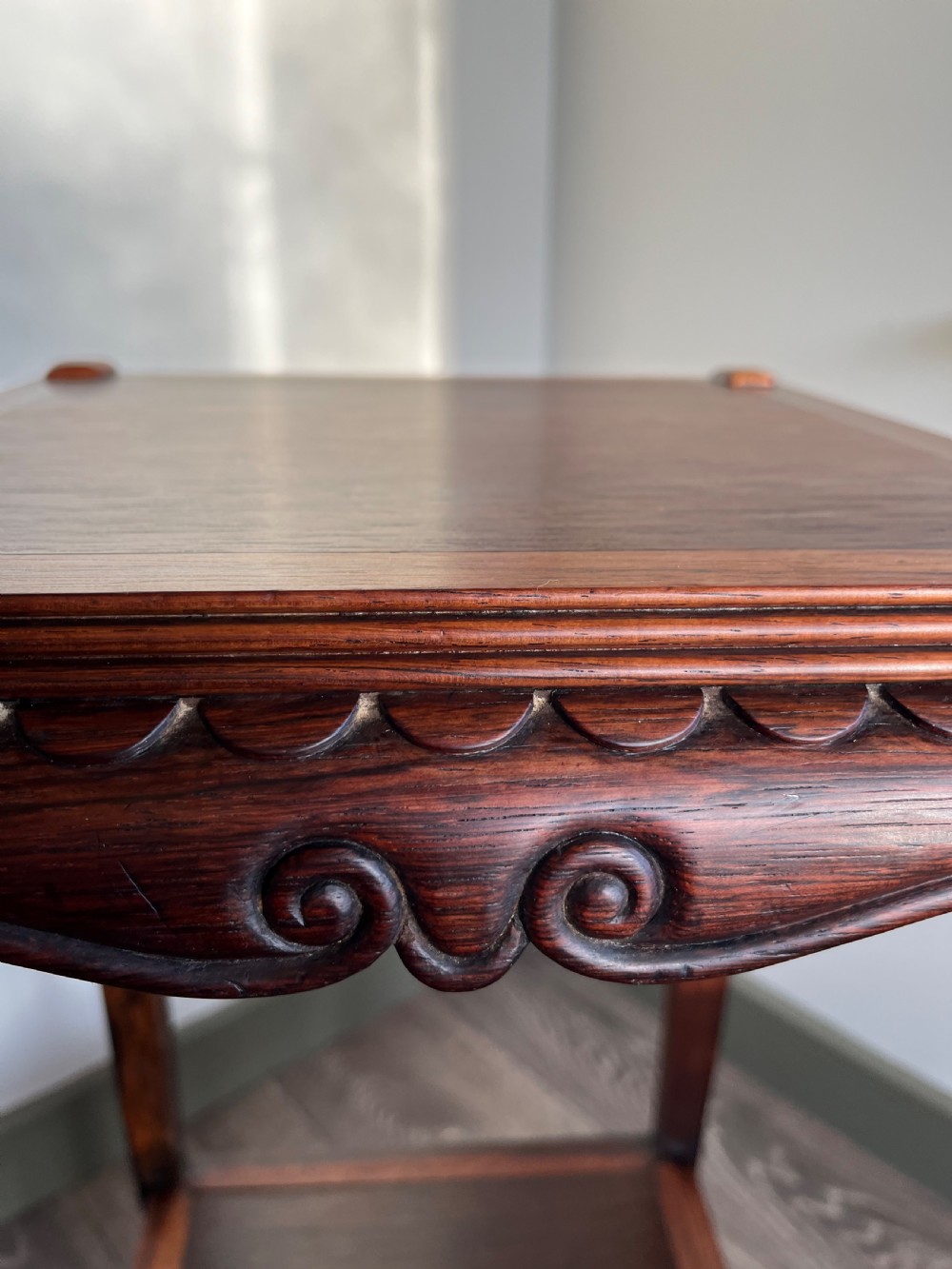 A tall, square antique rosewood lamp table featuring carved aprons, a lower shelf tier, and slender legs ending in carved feet. View VII