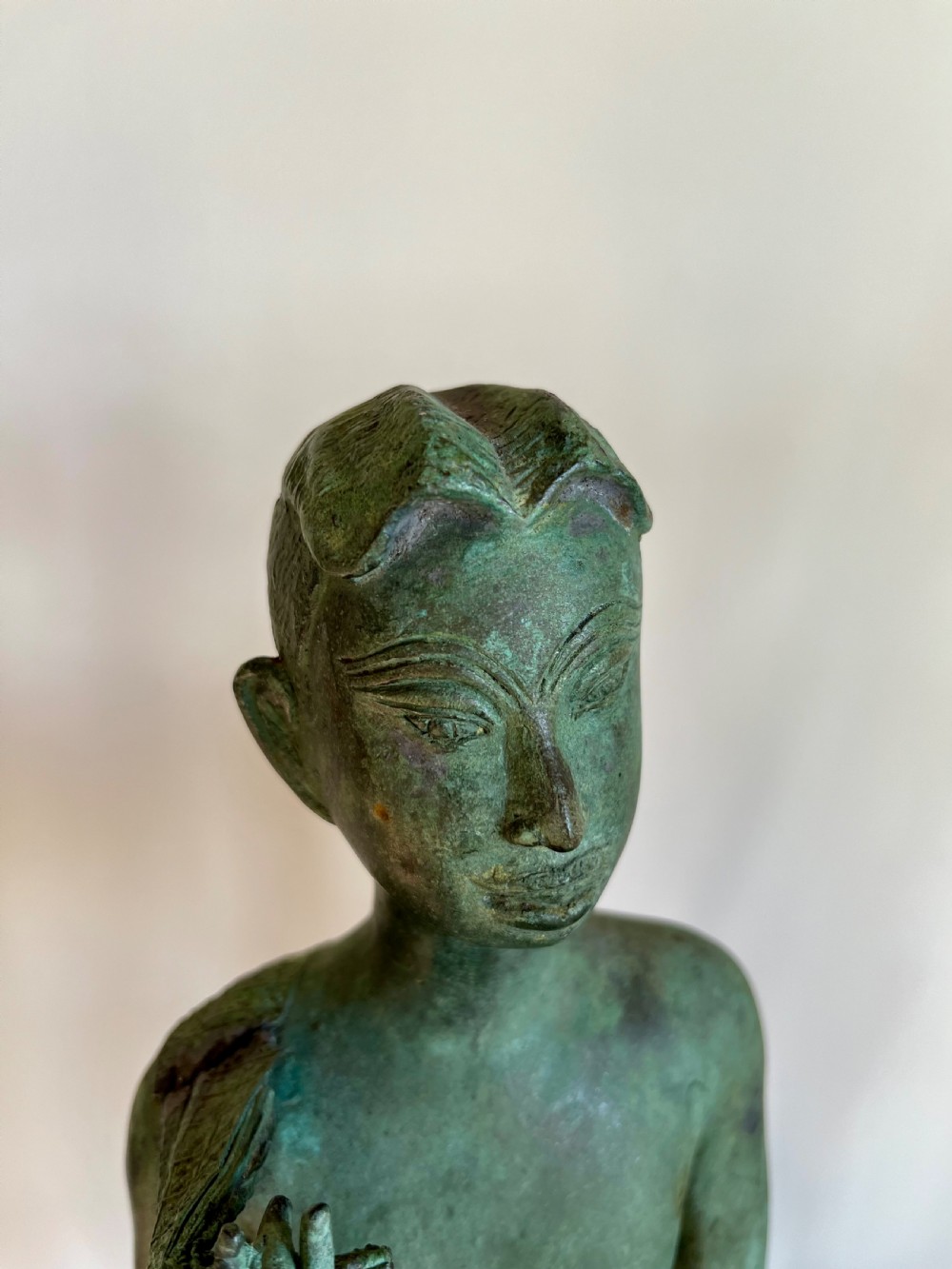 A pair of full-length bronze statues depicting a standing male and female figure with a green verdigris patina, positioned on rounded carved bases. View VI