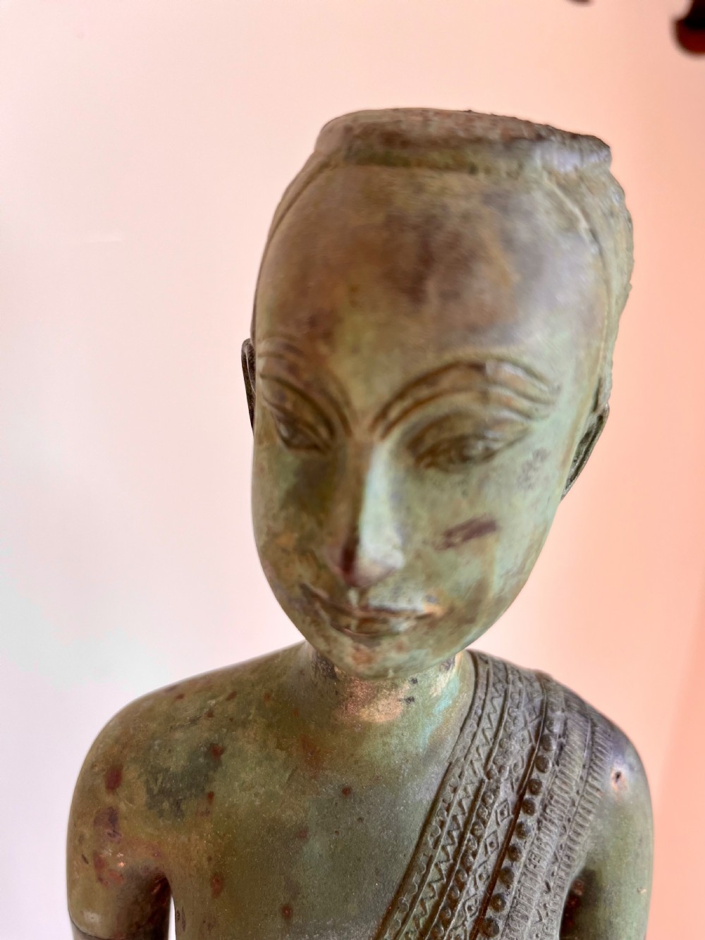 A pair of full-length bronze statues depicting a standing male and female figure with a green verdigris patina, positioned on rounded carved bases. View VII