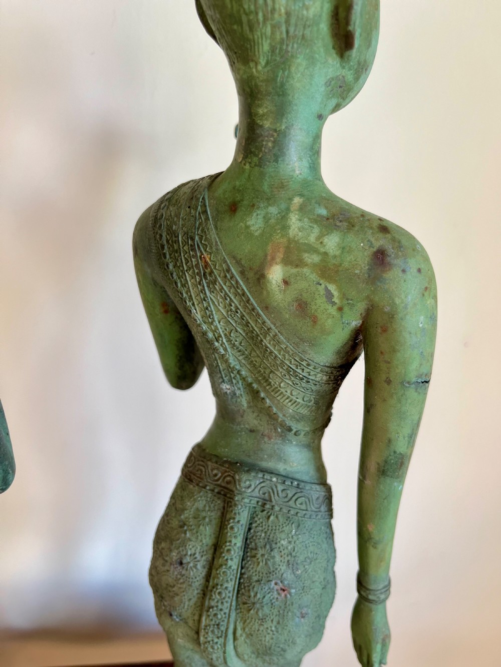 A pair of full-length bronze statues depicting a standing male and female figure with a green verdigris patina, positioned on rounded carved bases. View IX
