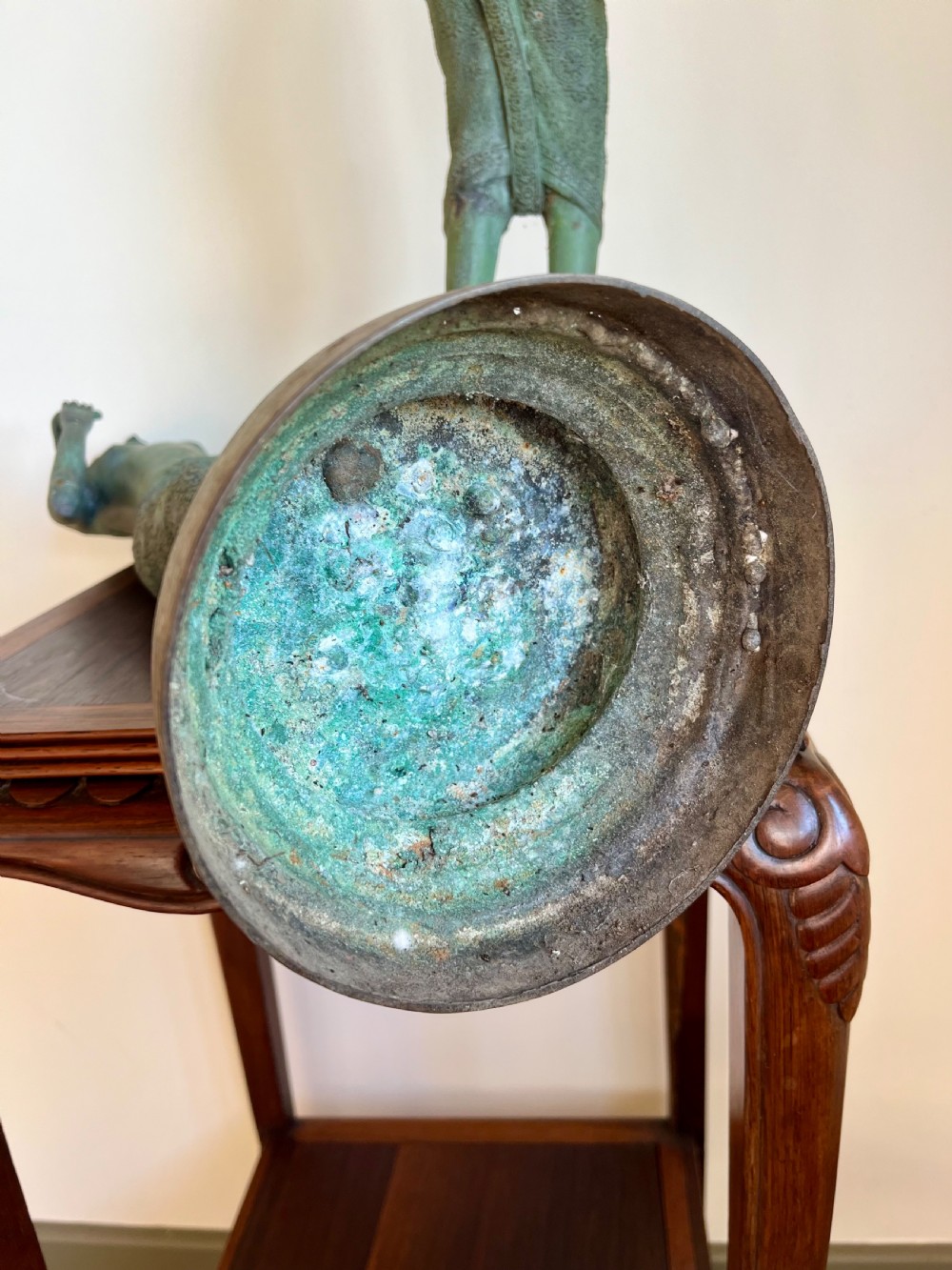 A pair of full-length bronze statues depicting a standing male and female figure with a green verdigris patina, positioned on rounded carved bases. View X