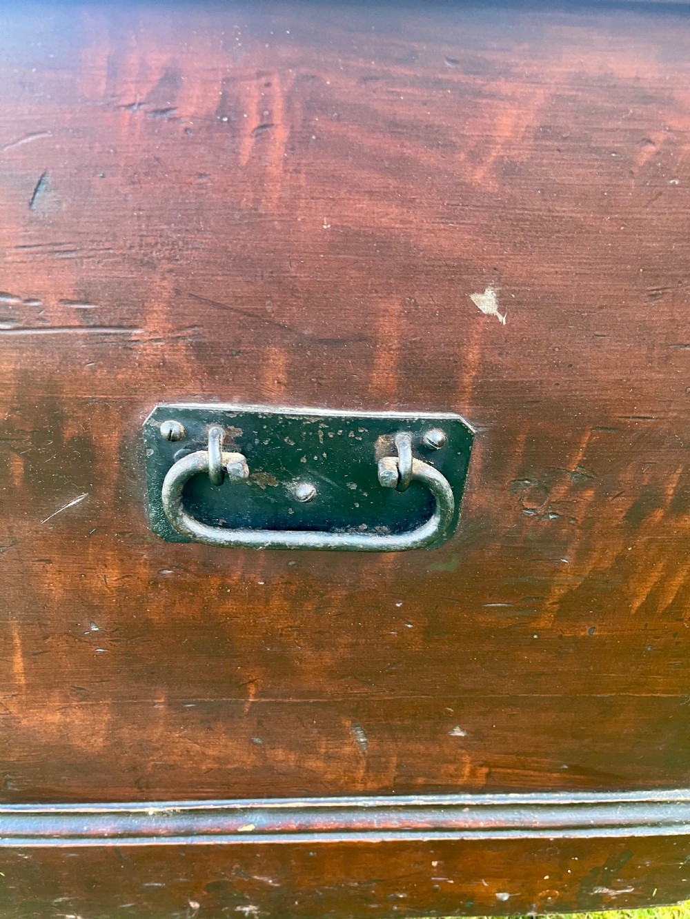 A rectangular dark reddish-brown pine storage chest with a hinged lid, painted panel border detail, and iron side handles. View XIV