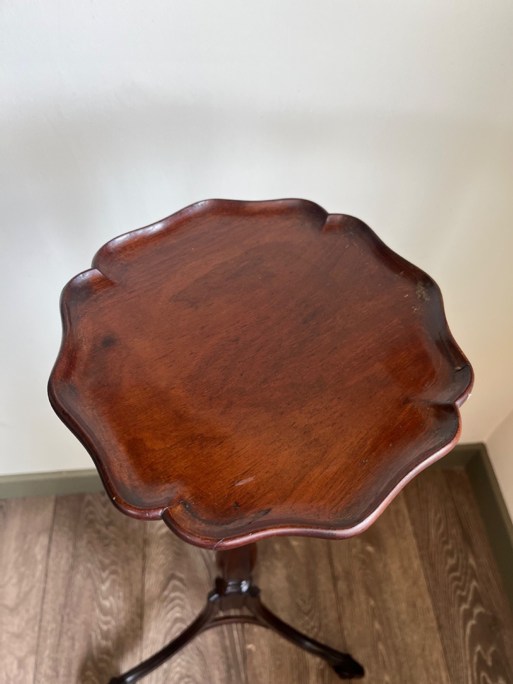 A dark mahogany torchere plant stand featuring a scalloped circular top, a turned column shaft, and a tripod base with scrolled feet. View VI
