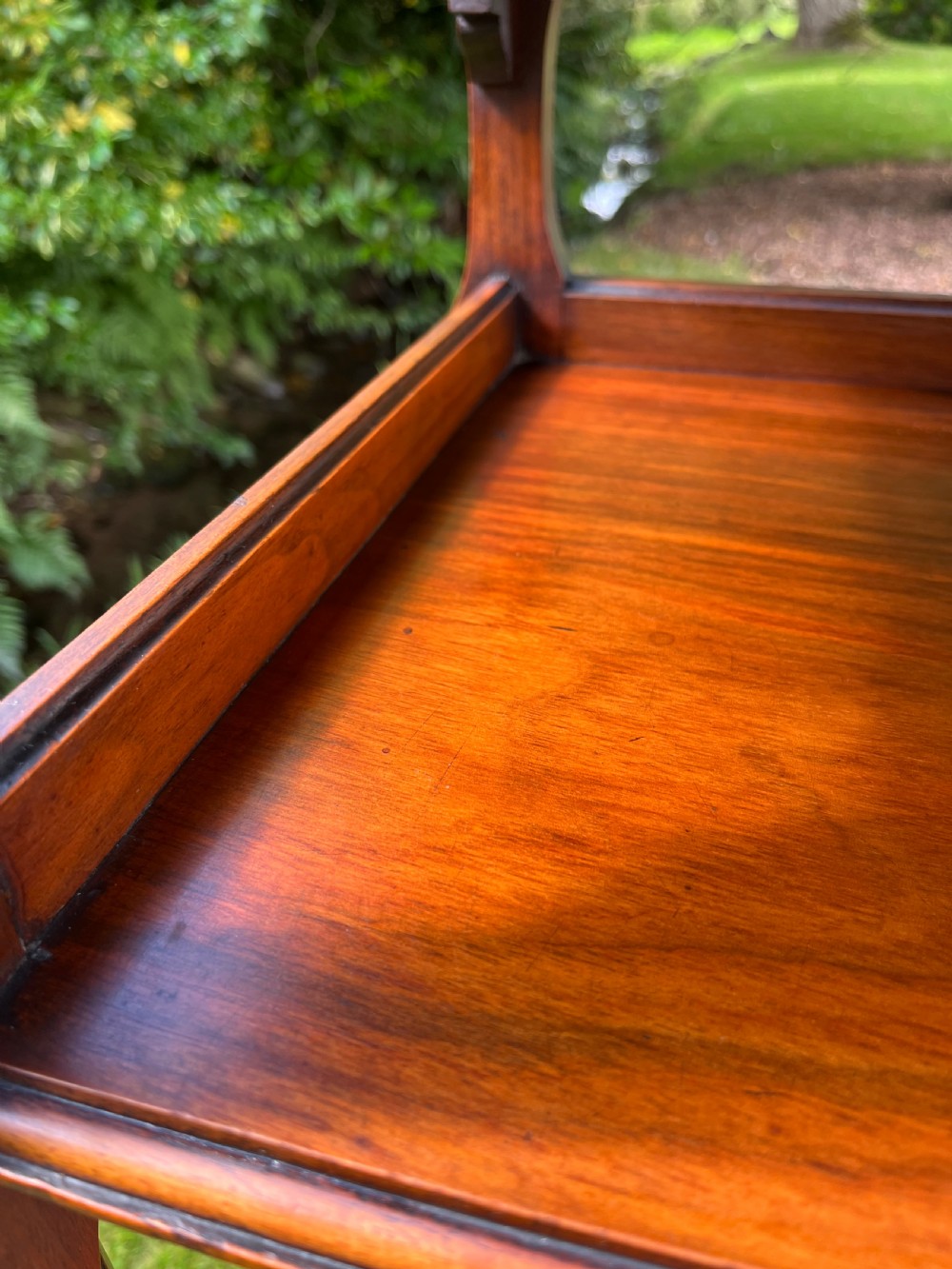 A three-tiered walnut wooden console table featuring a shaped gallery top, carved aprons, and slender tapered legs. View XII