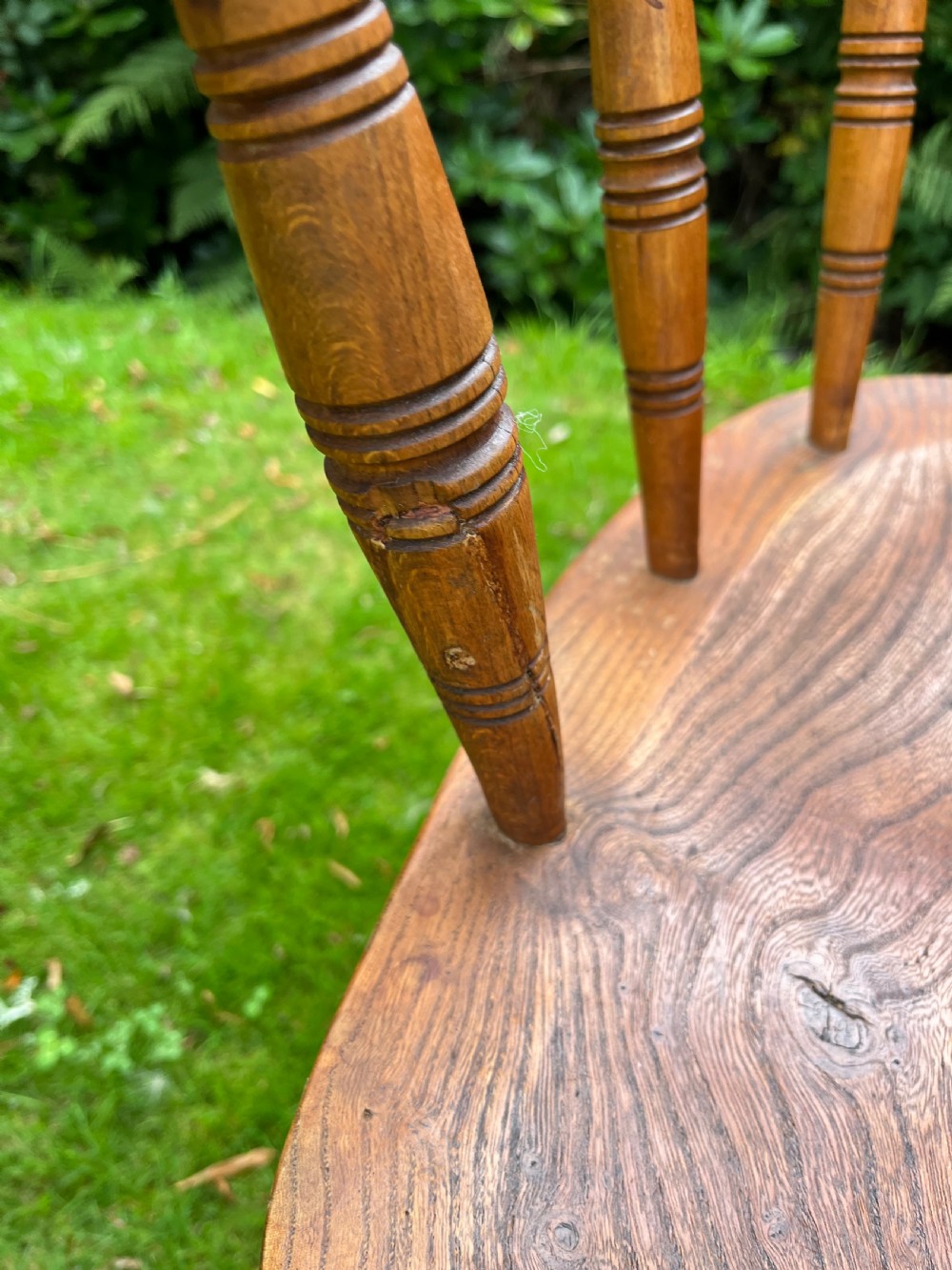 A pair of warm brown wooden smokers bow armchairs with turned spindles, contoured saddle seats, and turned legs. View IX